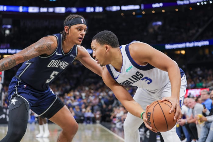 Orlando Magic forward Paolo Banchero defending Dallas Mavericks forward Grant Williams.